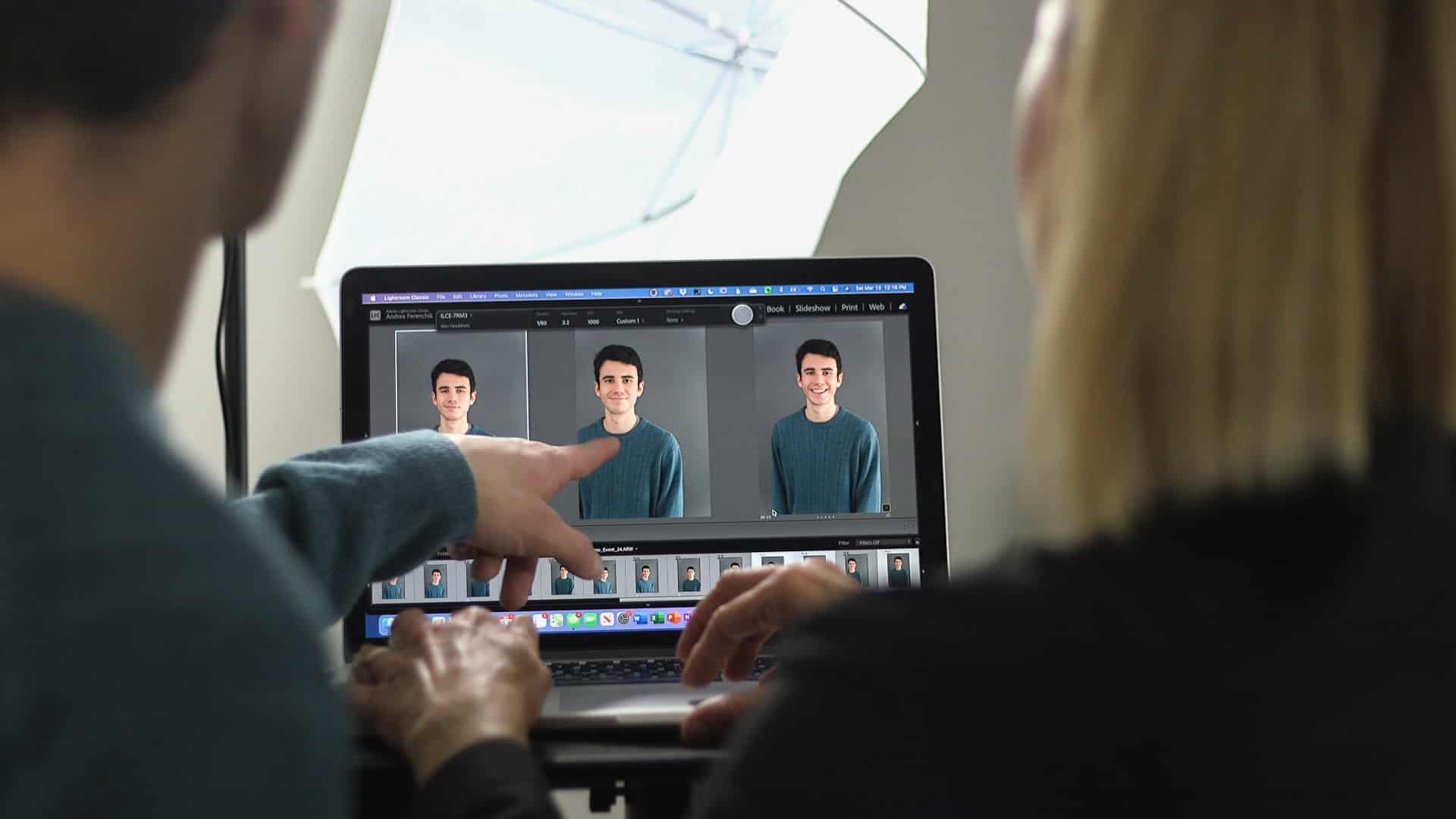 man pointing to his headshot on the screen