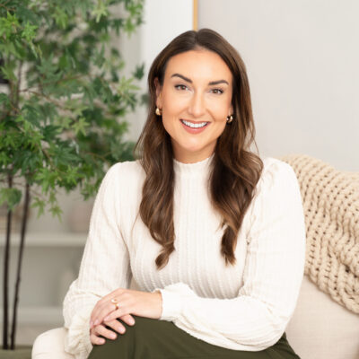 Image of woman in a relaxed pose with a warm smile.