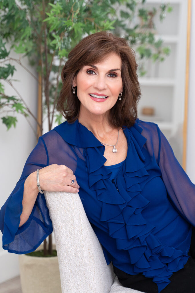 Woman confidently smiling for the camera for her author headshot