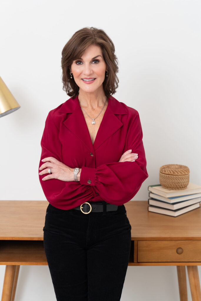 Woman confidently posing in front of desk